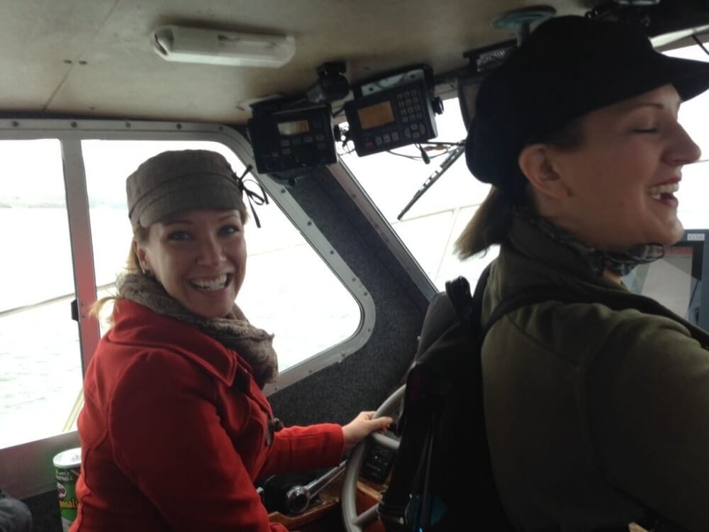 Rachelle Driving the boat around Hook Peninsula.