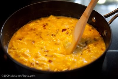 Cooking scrambled eggs with onions.