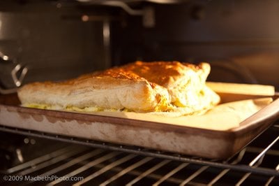 Baking puffed pastry in the oven. The crust has started to rise and turn golden.