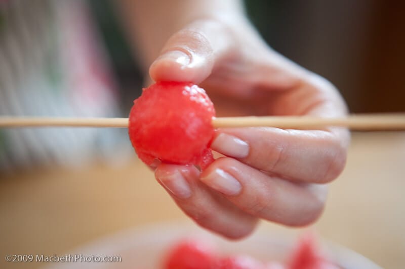 Using a watermelon ball on a bamboo skewer for garnish.