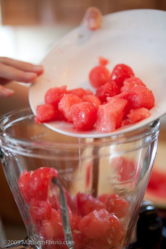 Pouring extra watermelon juice into blender.