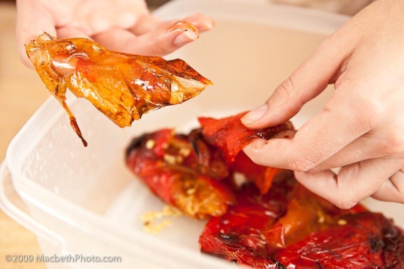 Removing the skin from the red peppers. It slides off easily after letting them rest.