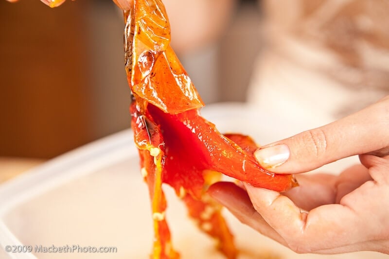Peeling away the skin from roasted red peppers.