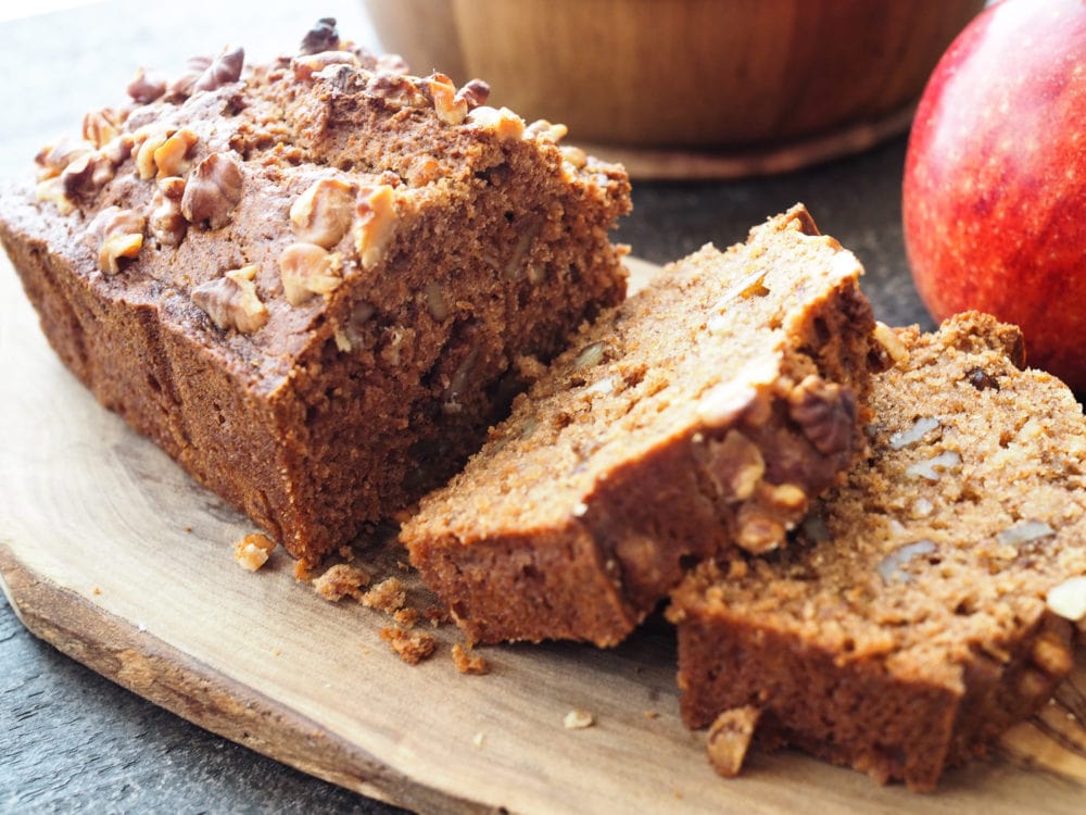 Spiced Apple Bread sliced on a wood serving board - TheTravelBite.com