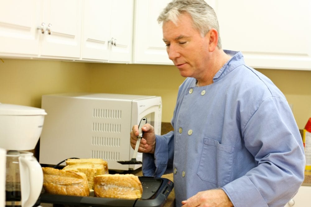 Chef Jim flipping the Ricotta & Raspberry Stuffed French Toast with a spatula.