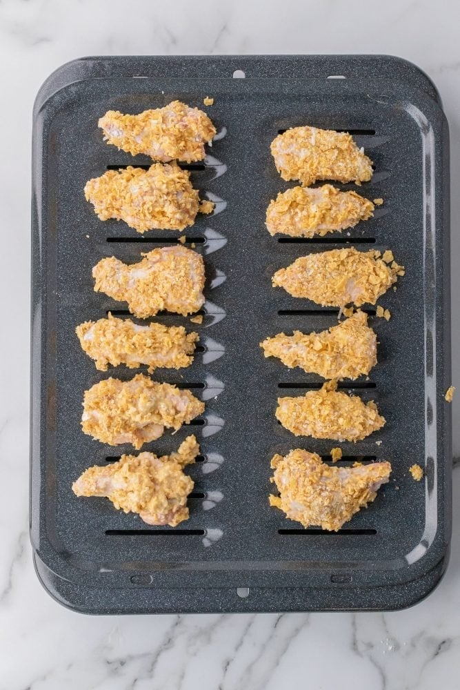 Sunchips coated wings placed on broiler pan.