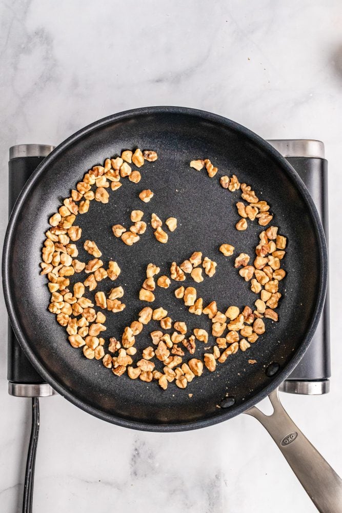 Toasting walnut peaces in a dry (no oil) sauté pan.
