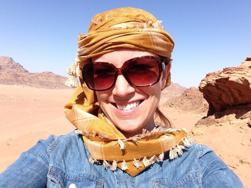 Rachelle wearing a head scarf and big sunglasses to help with sun and sand in the desert.