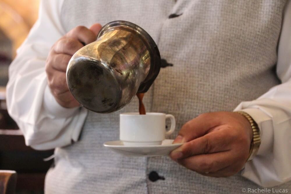 Pouring a cup of cardamom coffee in Jordan