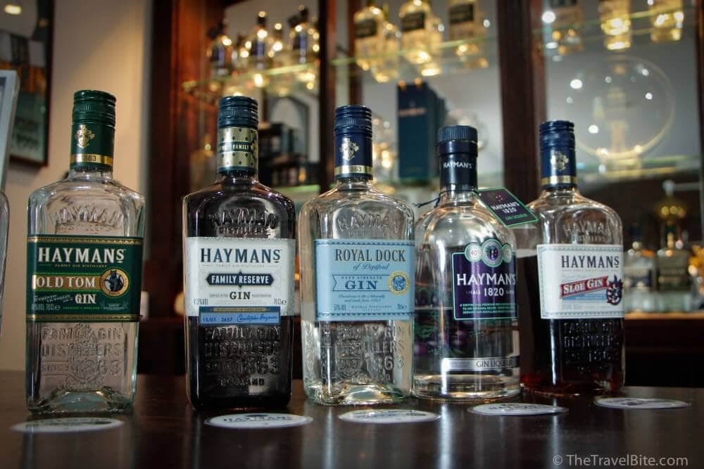 Different types of gin lined up on a bar included Old Tom gin, Hayman's Family Reserve, Royal Dock Gin, Haymans 1820, and Hayman's Sloe Gin.