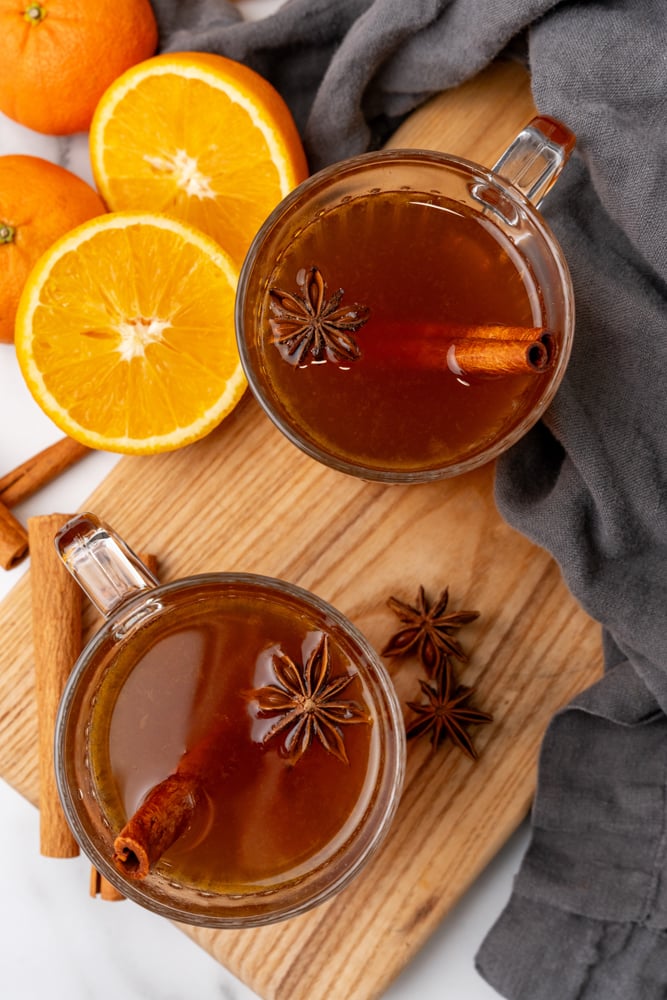 two clear cups with hot spiced cinnamon rum