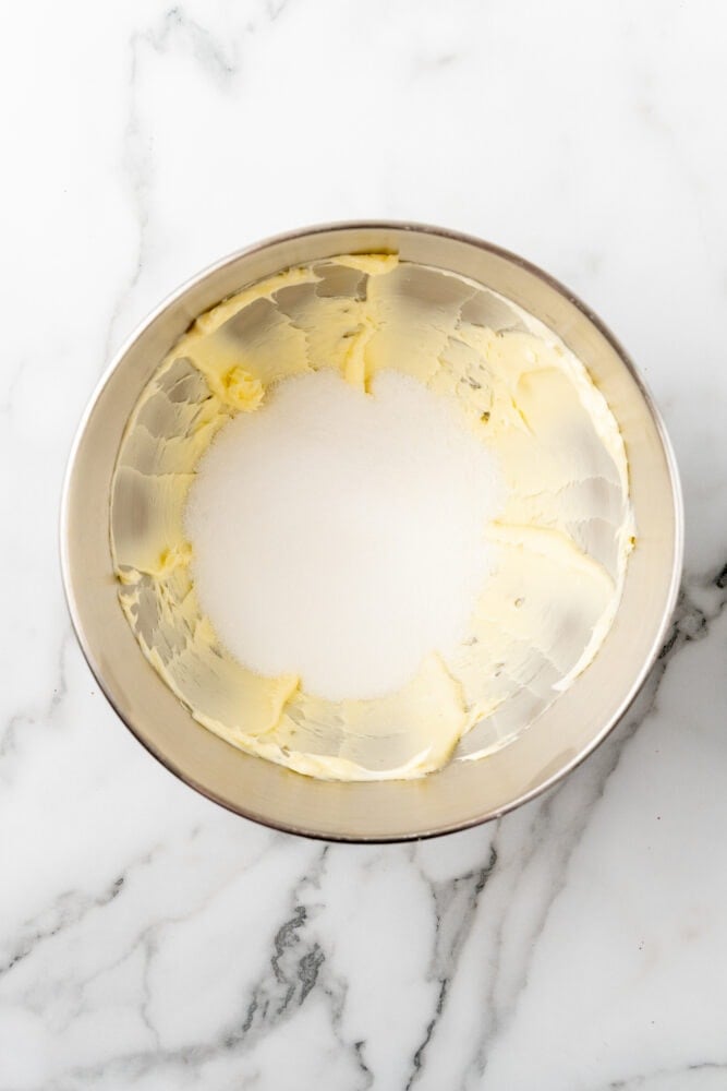 Softened butter whipped in stainless steel bowl with sugar added.