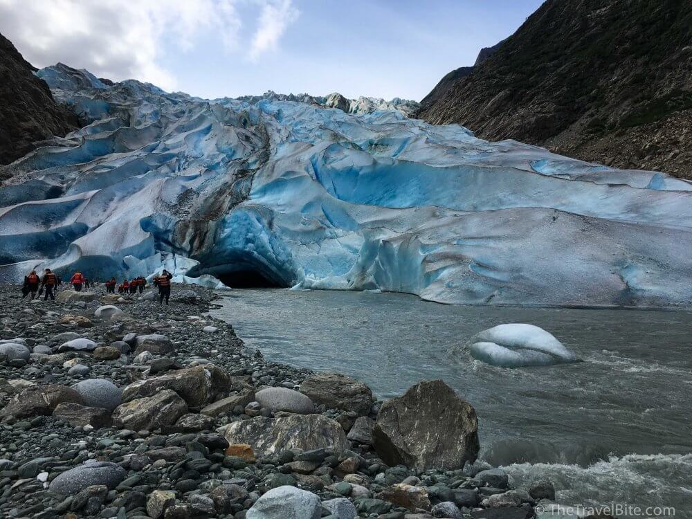 Rocky shoreline showing the ice melt from Davidson Glacier.