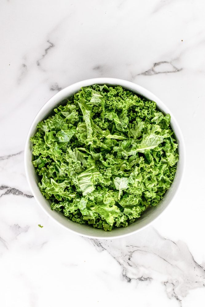 Chopped kale in a white bowl.