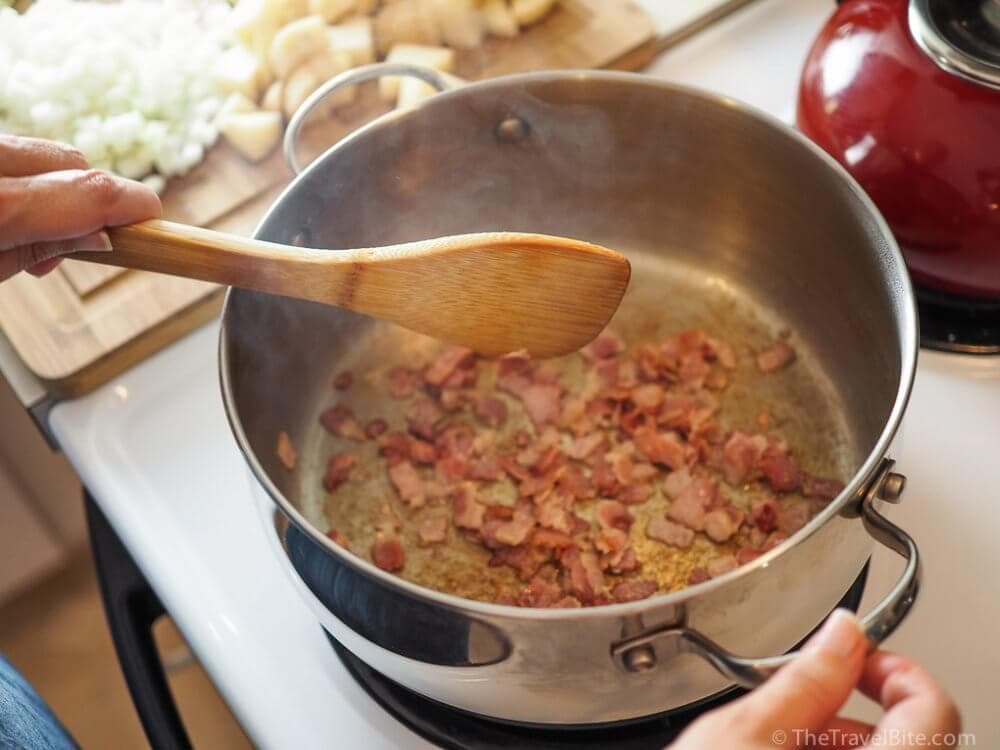 Browning bacon in a pan.