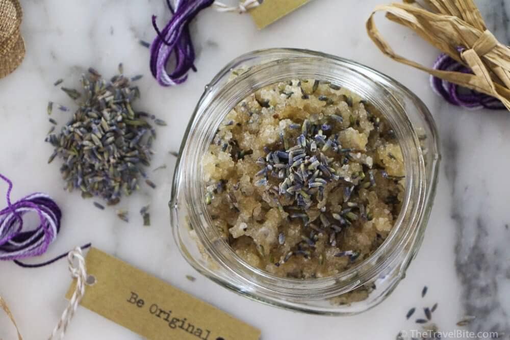 Close up of DIY Honey Lip Scrub with Lavender with brown sugar and purple lavender buds.