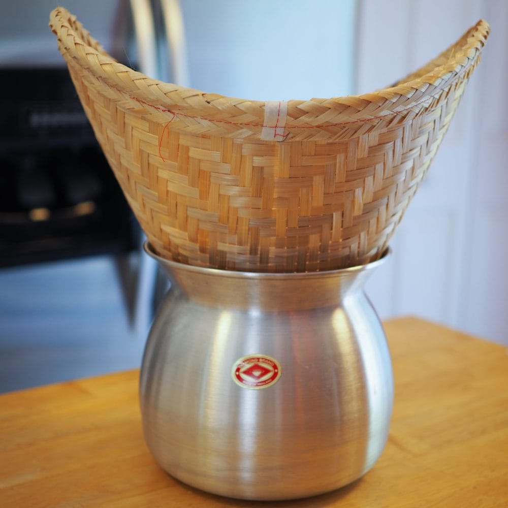 Traditional sticky rice bamboo steamer basket and pot.