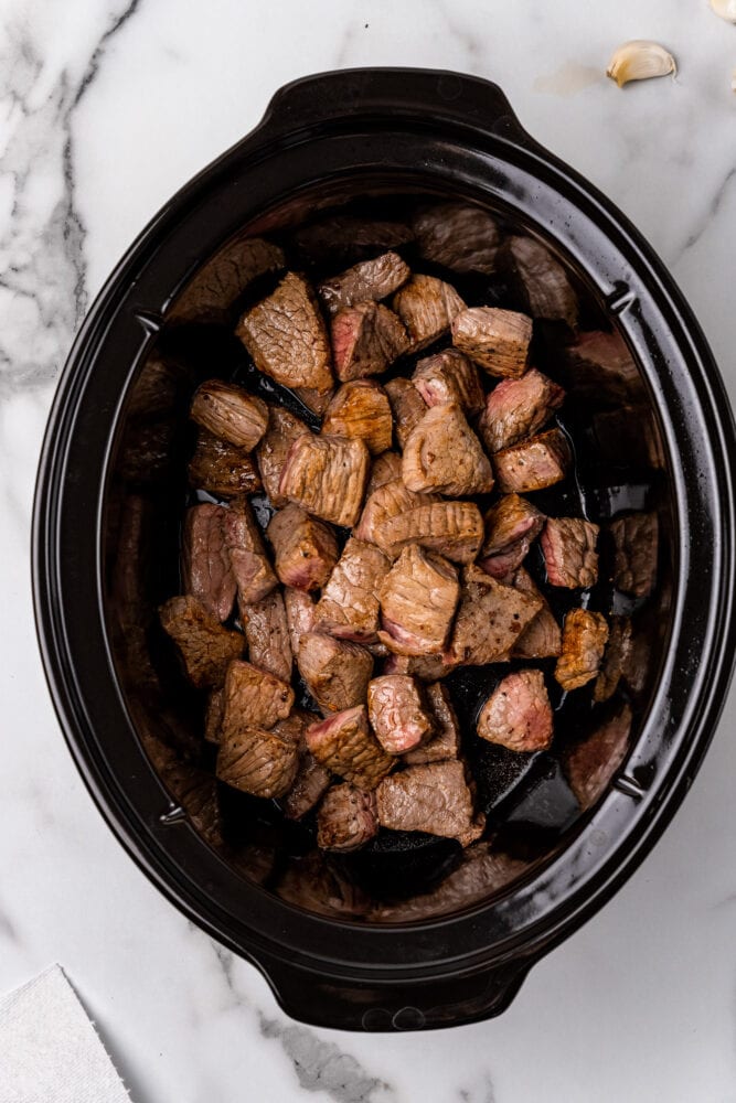 browned beef in a slow cooker