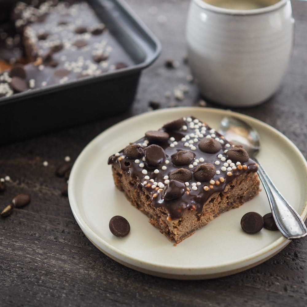 mocha brownie on a plate with coffee in the background