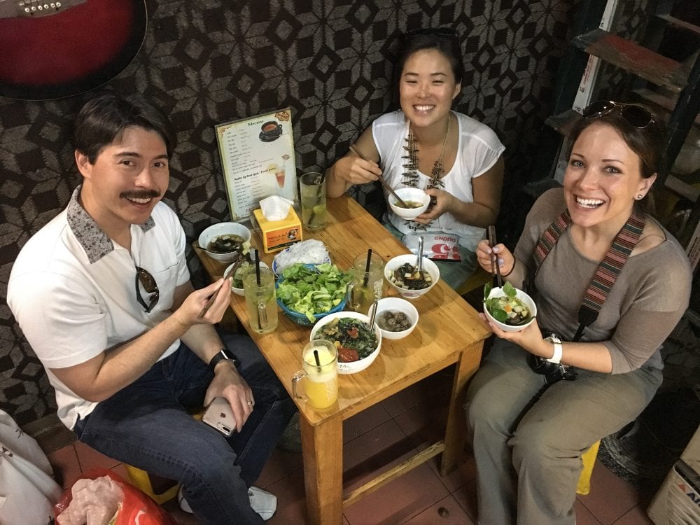 Pete and Rachelle enjoying bun cha with their host in Vietnam