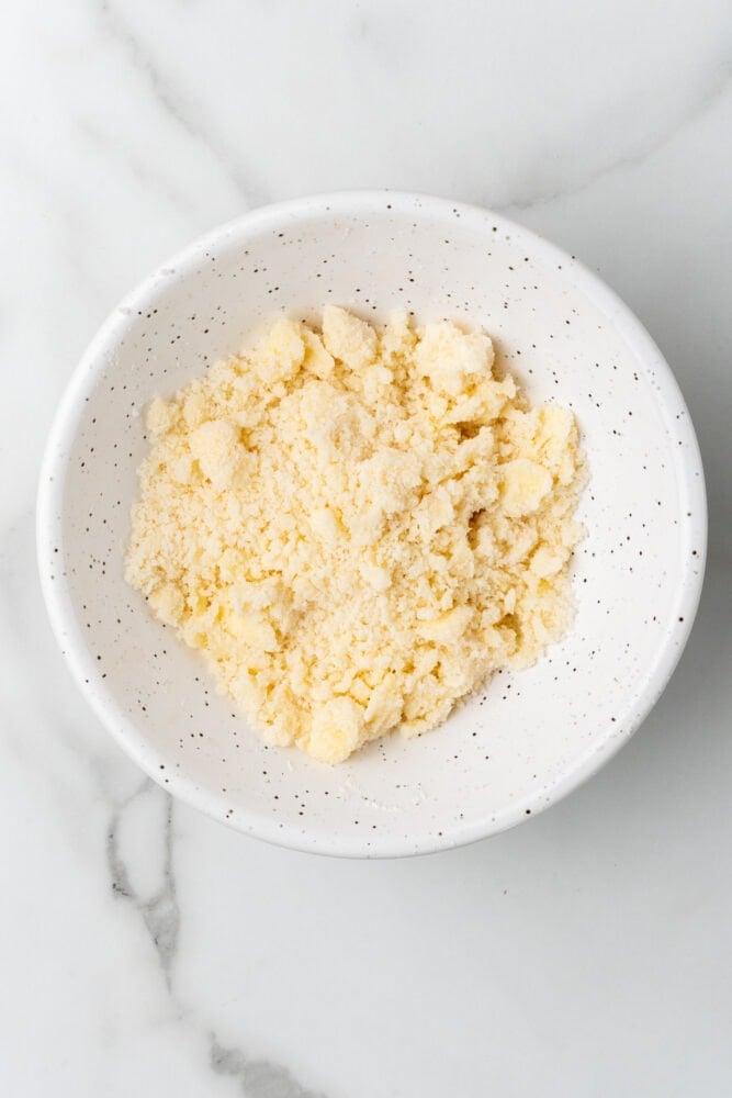 butter, sugar, and flour mashed together to make crumble topping