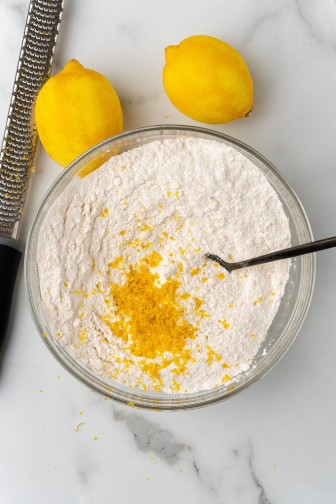 zesting lemon over flour and sugar