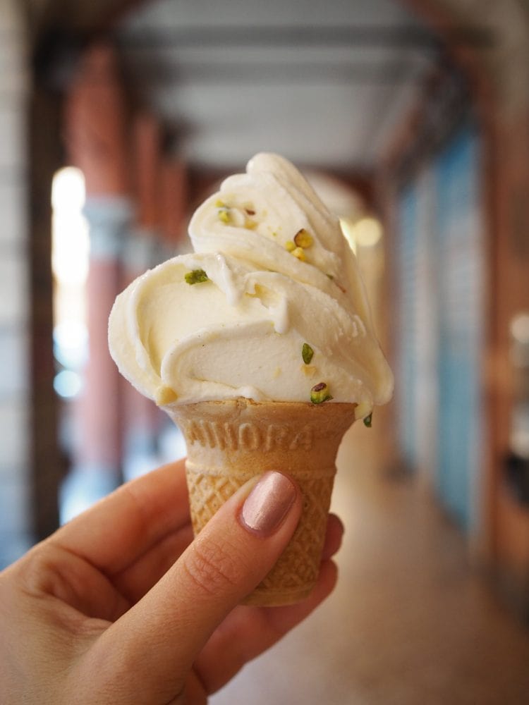 A tiny pistachio gelato held up underneath the porticoes of Bologna. 