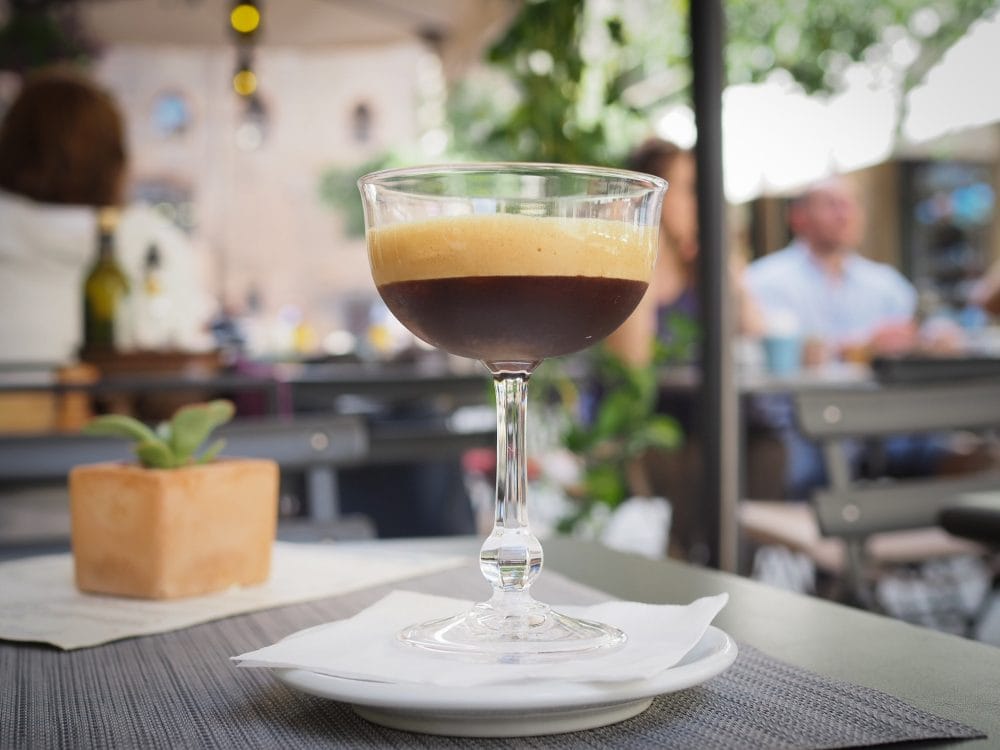 A shakerato, an Italian "iced" coffee where espresso and sugar is shaken with ice and poured into a martini glass.