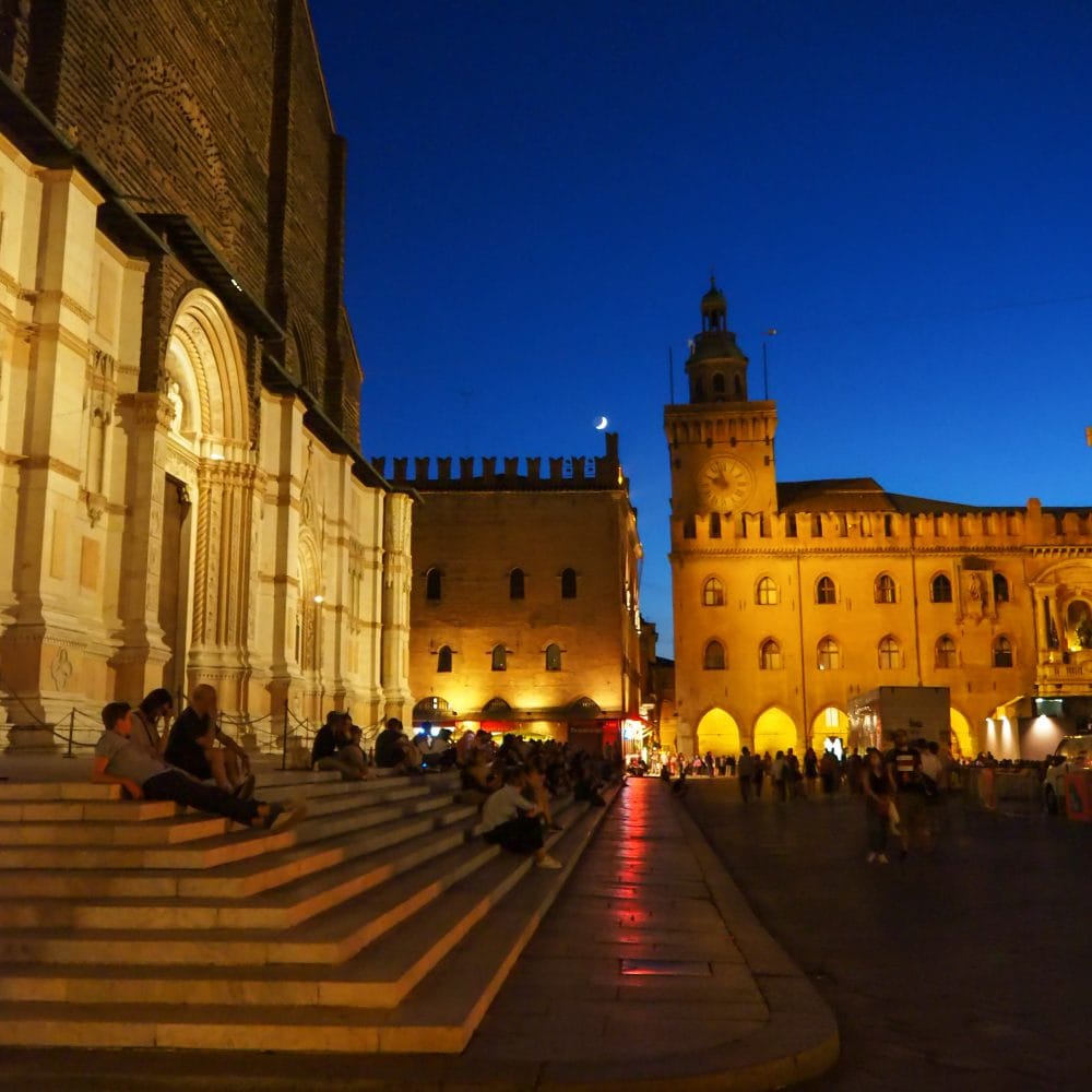Piazza Maggiore in Bologna at twilight.