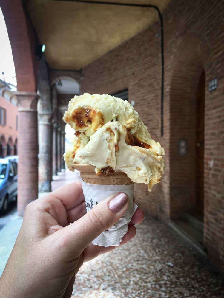Bologna Food: A small cone of ricotta and fig gelato underneath Bologna's porticoes. 