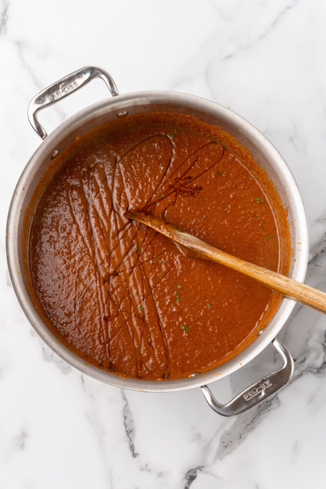 Drizzling honey over spicy tomato soup as a final touch.