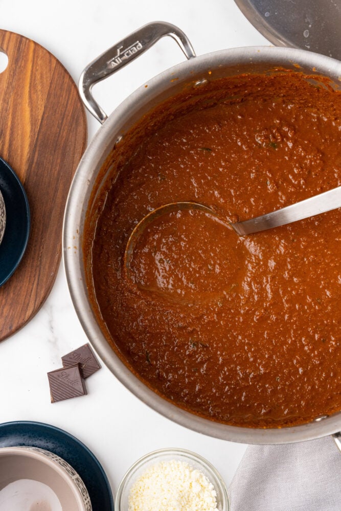 Ladle scooping out a serving of spicy tomato soup.