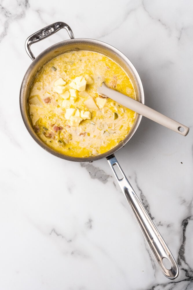 Adding butter to colannon soup.