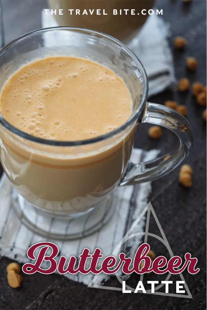 Pinterest Pin of Hot butterbeer in a clear glass mug with a French Press coffee maker and sprinkles of butterscotch chips.