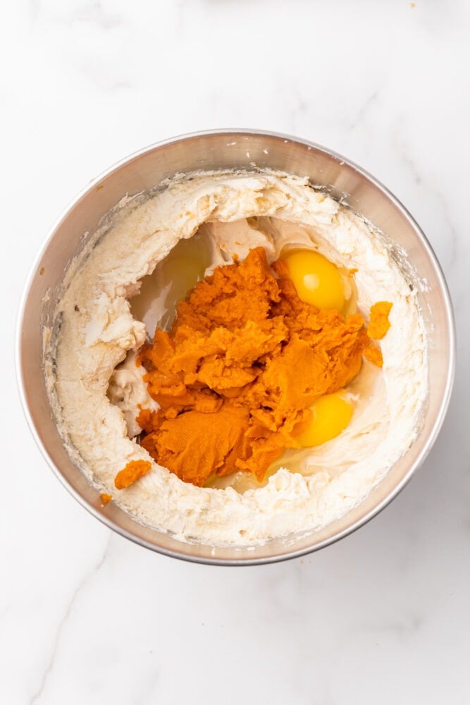 Eggs and pumpkin added to cream cheese and brown sugar mixture.