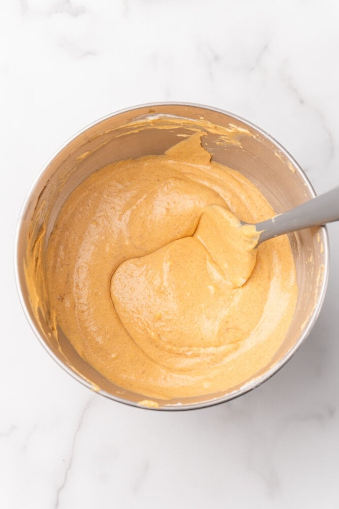 pumpkin cheesecake filling in a stainless steel bowl after blending all ingredients.