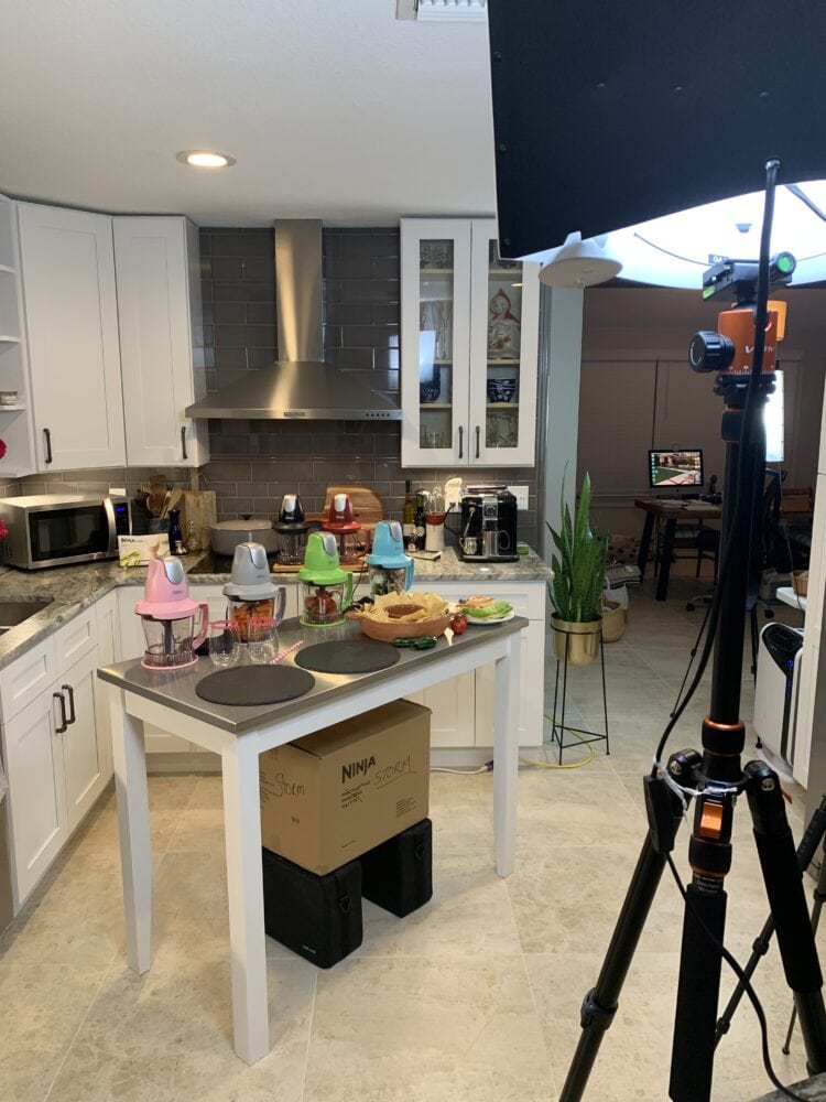 At home camera studio set up in our kitchen with food displayed on the island and lights lighting up the room