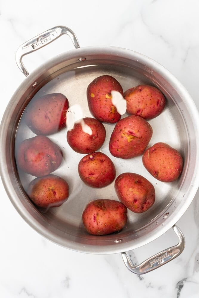 boiling red potatoes in a stainless steel pot
