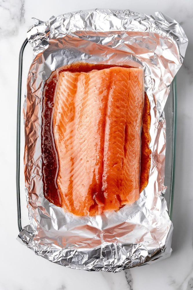 Sockeye Salmon in foil wrapper with maple glaze before it is cooked.