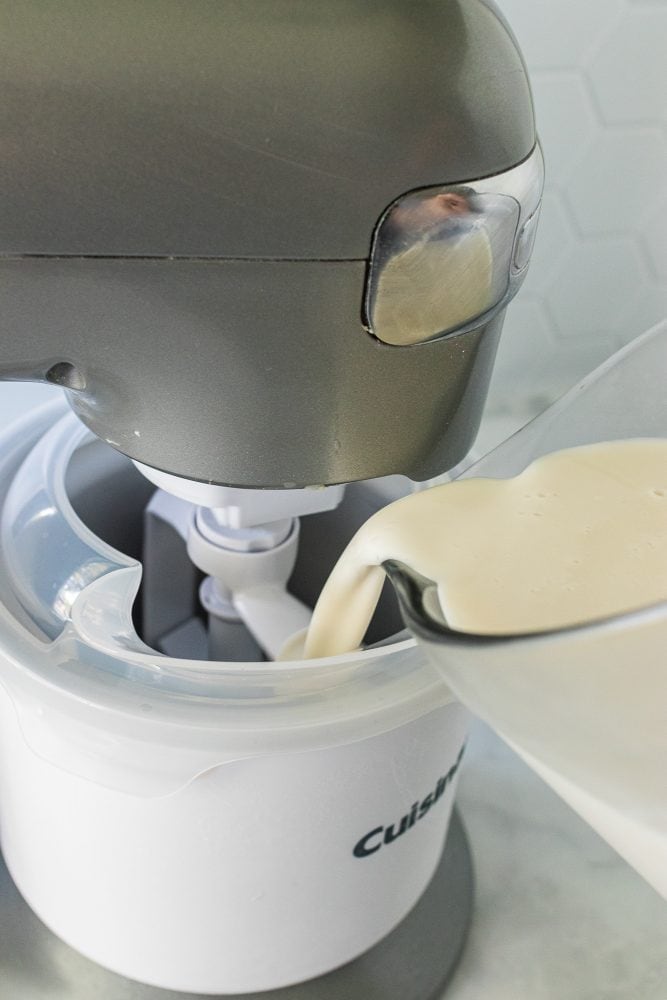 Pouring coconut ice cream mixture into ice cream maker.