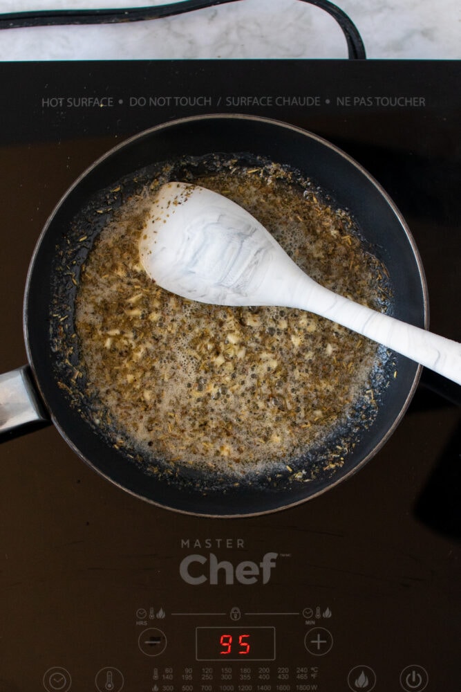 Overhead shot of cooking Italian seasoning in sauté pan with butter.