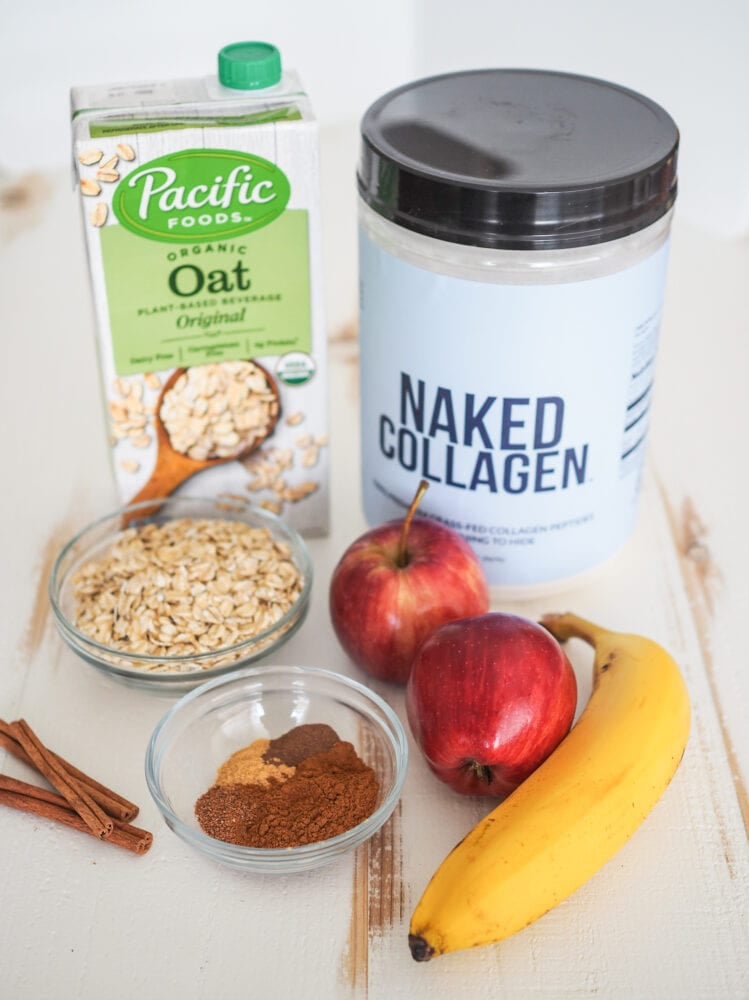 Photo of ingrediets for apple smoothie including oat milk, collagen powder, oatmeal, apples, banana, and spices.