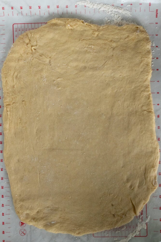Overhead shot of the dough rolled out into a rough rectangle. 