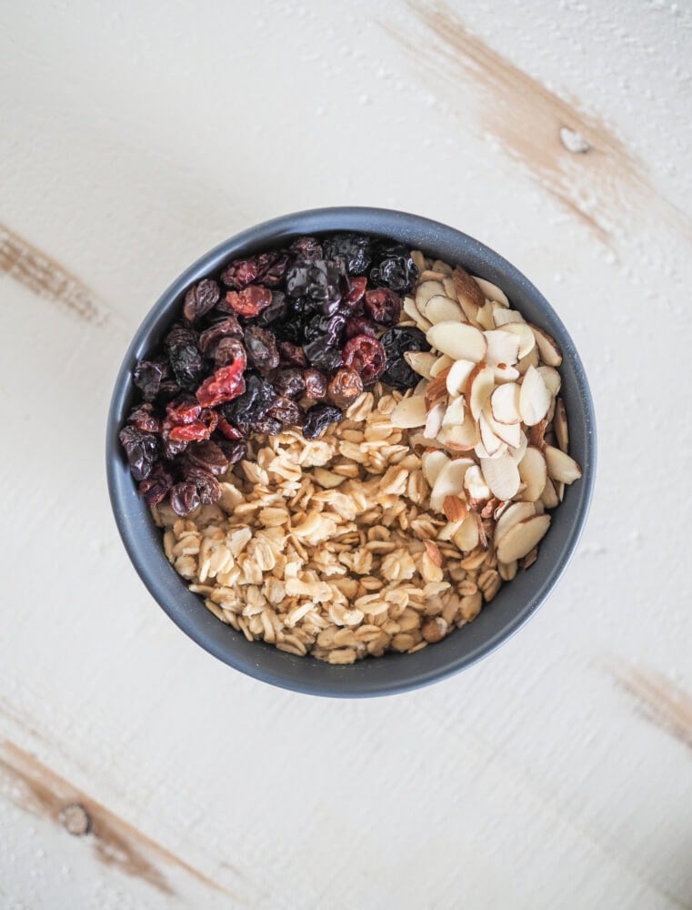 Overhead shot of microwave oatmeal with dried berry mix and almond slices.