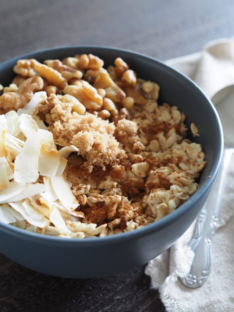 Microwave oatmeal with toasted coconut shavings, walnuts, brown sugar, and cinnamon.