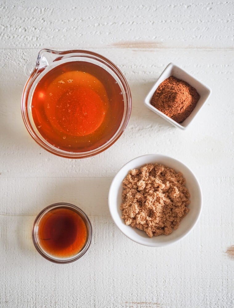 Overhead shot of microwave oatmeal spices and sweeteners including honey, brown sugar, cinnamon, and vanilla.