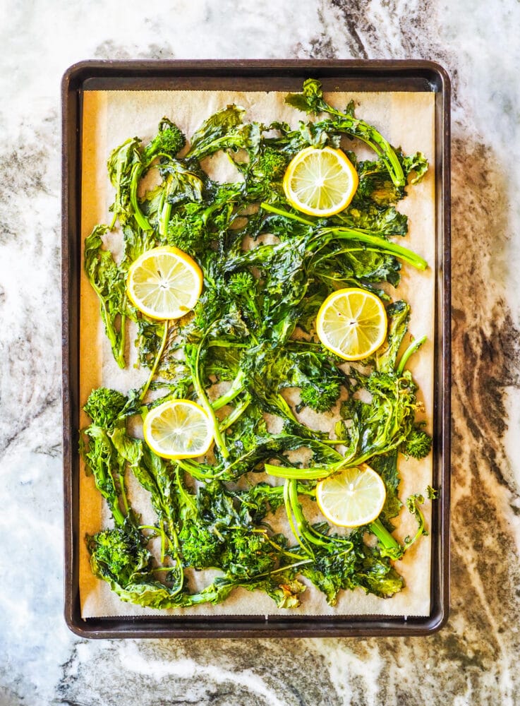 Rapini on a sheet pan after roasting in the oven.