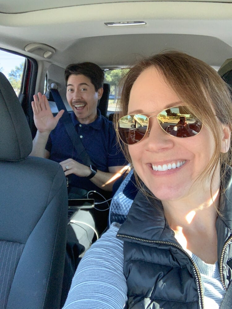 Pete and Rachelle inside a car preparing for a road trip.