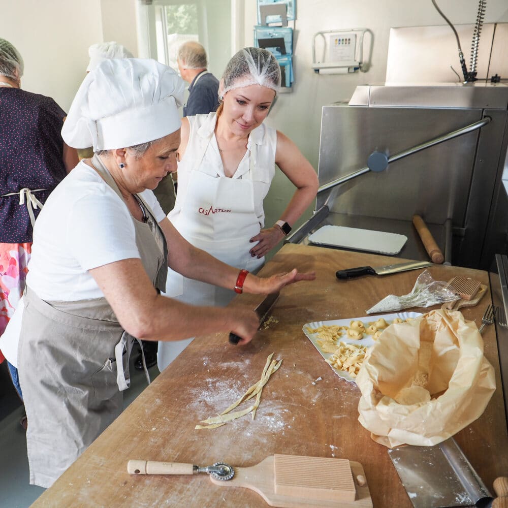 Delia instructing Rachelle how to cut the pasta.