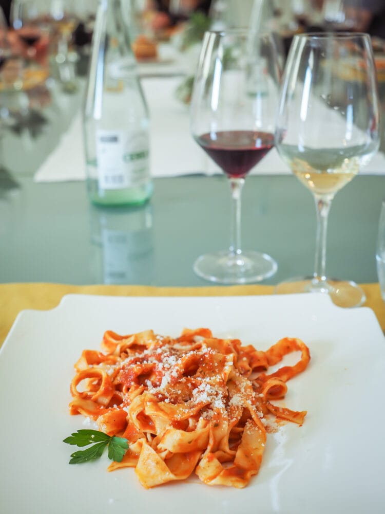 Lunch served at the end of class: handmade pasta with sauce and a glass of local wine.